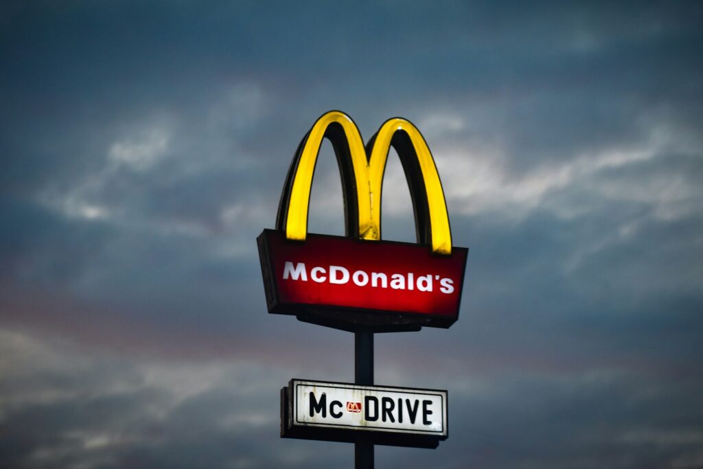 a mcdonald's sign with a cloudy sky in the background, mcd stock forecast