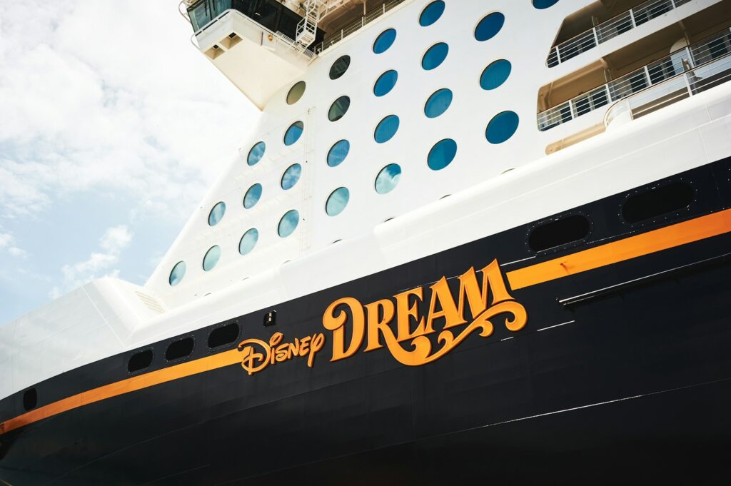 a disney cruise ship with the word dream painted on it, dis dividend